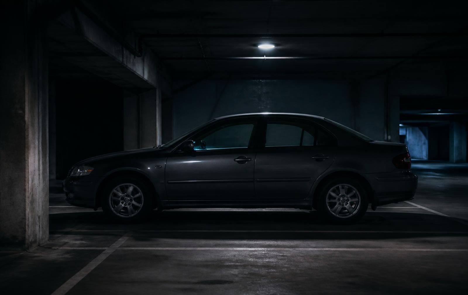 A driver backs into a parking garage pillar.